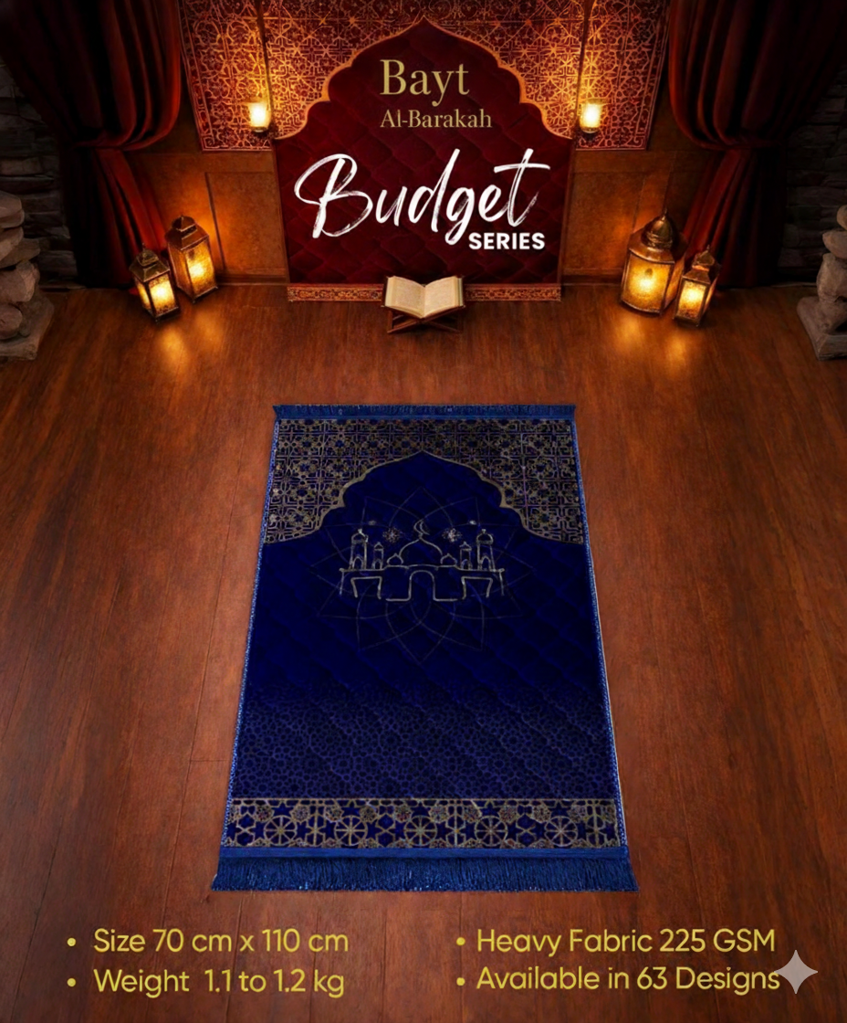 Blue prayer mat with intricate design on a wooden floor, featuring 'Bayt Al-Barakah' branding.