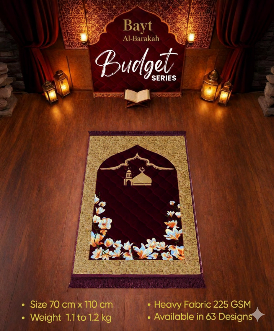 Decorative prayer mat with floral design on a wooden floor, featuring 'Bayt Al-Barakah' branding.
