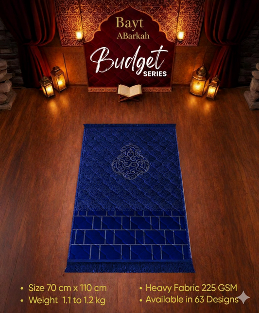 Blue prayer mat with intricate design on a wooden floor, featuring 'Bayt Abarkah' branding.